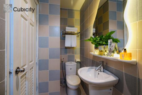 a bathroom with a toilet and a sink at Cubicity Walking Street in Ho Chi Minh City
