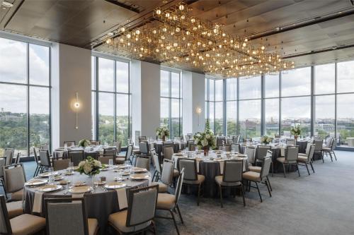a banquet hall with tables and chairs and windows at Hilton Arlington Rosslyn The Key in Arlington