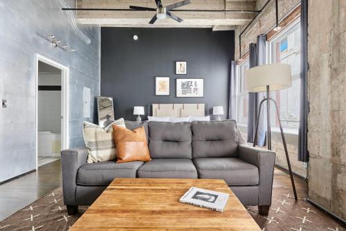 a living room with a couch and a table at Reside Houston Downtown, a Wyndham Residence in Houston