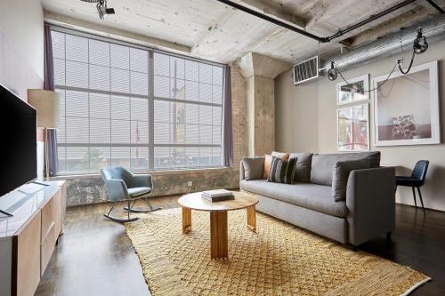 a living room with a couch and a table at Reside Houston Downtown, a Wyndham Residence in Houston