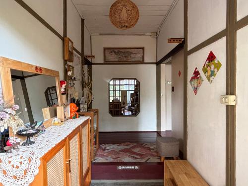 a living room with a counter and a mirror at 月光寶盒旅店 Moonlight Hostel in Kaohsiung