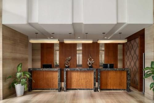 an office lobby with wood paneling and wooden doors at Ramada by Wyndham Ghaziabad Vasundhara in Ghaziabad
