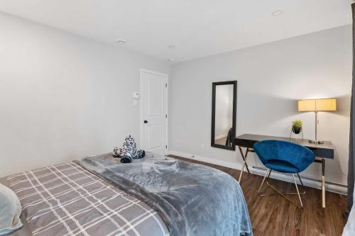 a bedroom with a bed and a desk and a mirror at Ultimate Comfort with Spa - Le Villa Joie in Saint Come