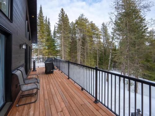 a balcony of a house with a wooden deck at Ultimate Comfort with Spa - Le Villa Joie in Saint Come