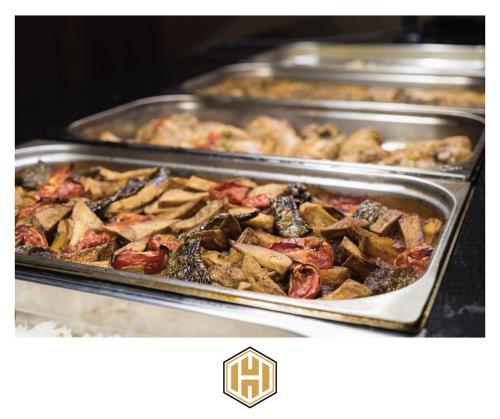 a bunch of trays of food on a stove at Ayder Hasimoglu Hotel in Ayder Yaylasi