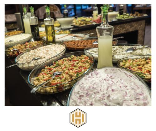 a buffet with many plates of food on a table at Ayder Hasimoglu Hotel in Ayder Yaylasi
