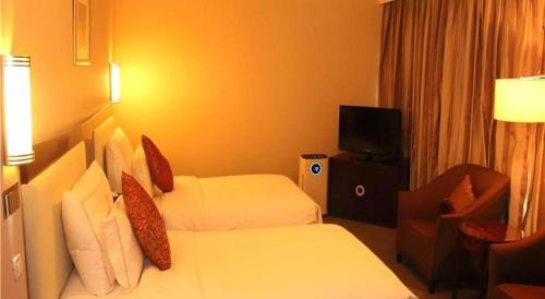Postel nebo postele na pokoji v ubytování Beijing Jinjiang Fuyuan Hotel