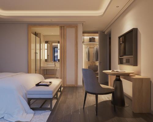 a bedroom with a bed and a table and a chair at HOTEL du LAC SIGNATURE in Hanoi