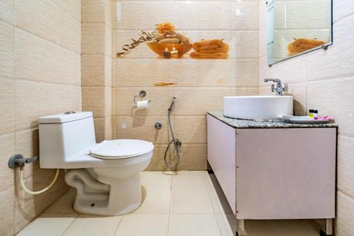 a bathroom with a toilet and a sink at Flutter Hotels & Resort in Lansdowne