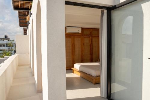 a bedroom from the balcony of a house at Modern 1BR with Rooftop Rice Fields & Seseh Beach Panorama in Cemagi