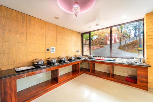 a kitchen with a counter with pots and pans at Flutter Hotels & Resort in Lansdowne