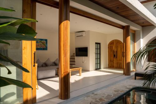 an open door to a living room with a tv at Modern 1BR with Rooftop Rice Fields & Seseh Beach Panorama in Cemagi