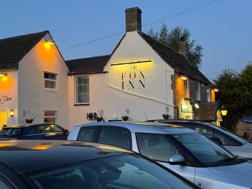 a building with a sign that reads top inn at The Fox Inn in Hawkesbury