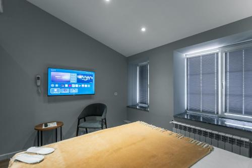 a bedroom with a bed and a flat screen tv at Capital City Hotel in Baku
