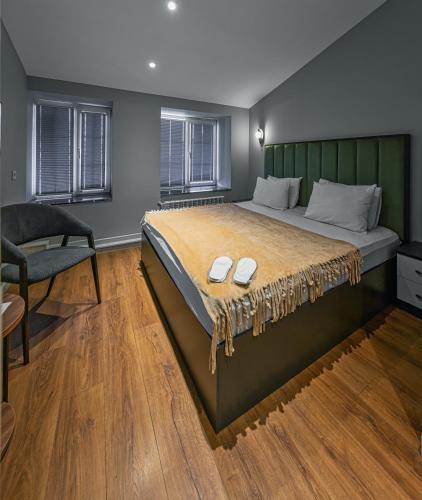 a bedroom with a large bed and a chair at Capital City Hotel in Baku
