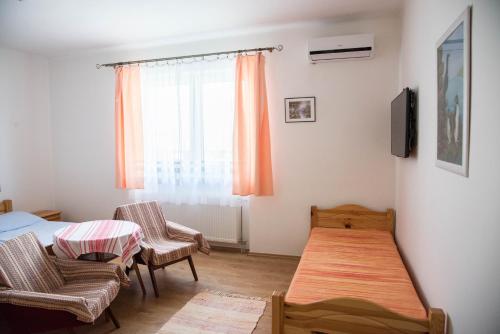 a room with a bed and a table and chairs at Ubytovanie Némethová in Štúrovo