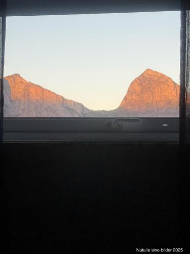 a window with a view of a mountain range at Stranda Apartment in Senja