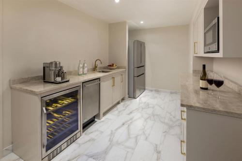a large kitchen with an oven with wine bottles at Waldorf Astoria Orlando - An Official Walt Disney World Hotel in Orlando