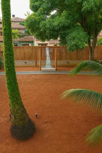 a palm tree and a ball in a park at Residência Thomas in Itacaré