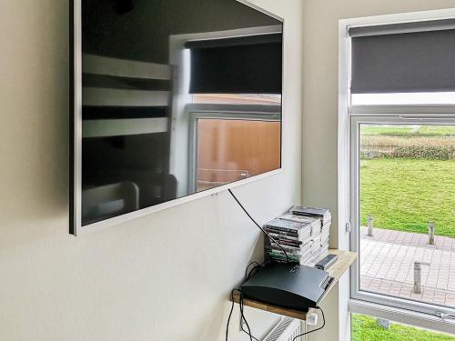 a mirror on a wall next to a window at Luxury Spa Apartment in Sondervig - By Traum Ferienwohnungen in Ringkøbing