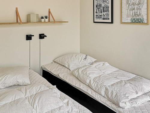two beds sitting next to each other in a bedroom at Luxury Spa Apartment in Sondervig - By Traum Ferienwohnungen in Ringkøbing