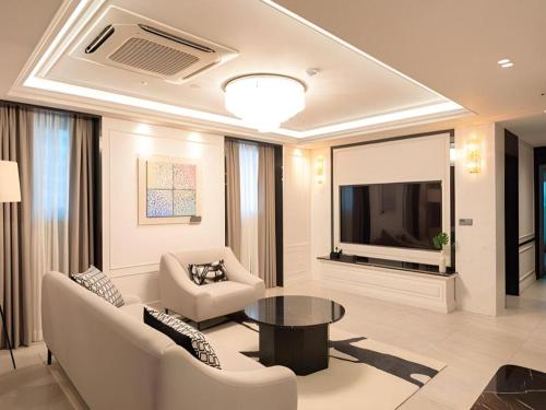 a living room with a couch and a table at HOTEL D EDITION in Daejeon