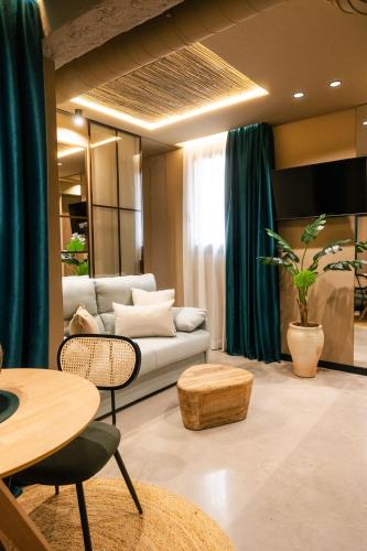 a living room with a couch and a table at Los 36 by GRUPO CCOMMO in Murcia