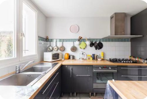 a kitchen with a sink and a counter top at Roissy CDG, private room 4 in Roissy-en-France