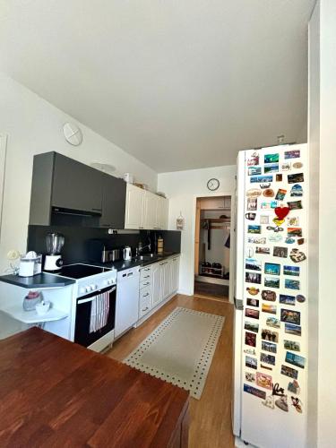 a kitchen with a refrigerator with magnets on it at Unique apartment in Kemi with sauna department Free parking in Kemi