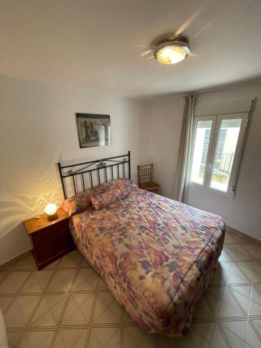 a bedroom with a large bed and a window at Casa de Pueblo in Sarratella
