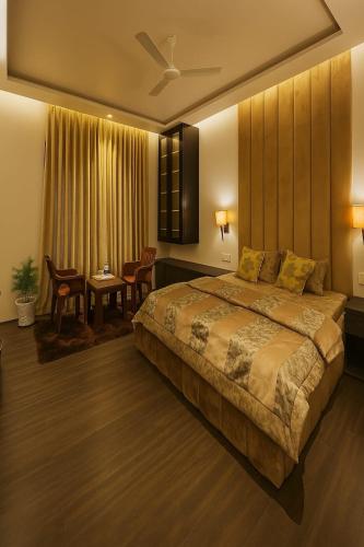 a bedroom with a large bed and a dining room at The Holiday Home in Srinagar