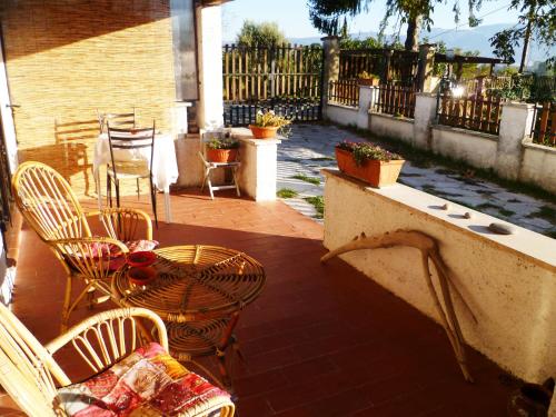 a patio with chairs and a table and a table and chairs at B&B Colle di Terria Country House in Contigliano