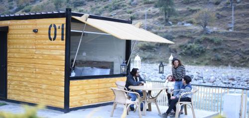 a group of people sitting at a table in a building at Marco Polo Resort Kaghan in Kāgān