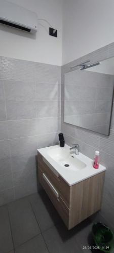 a bathroom with a sink and a mirror at nonna rosa in Reggio Calabria