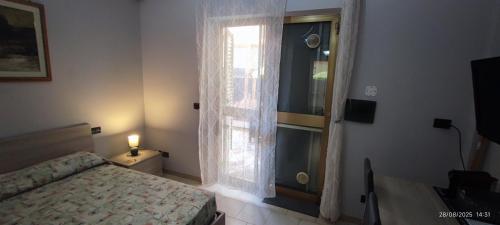 a bedroom with a bed and a window at nonna rosa in Reggio Calabria