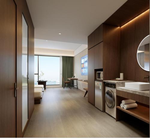 a bathroom with a sink and a washing machine at Guangzhou Xing Yi International Apartment - Poly World Branch in Guangzhou