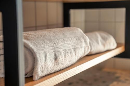 a towel is sitting on a shelf at HOP Apartments & Suites in Interlaken