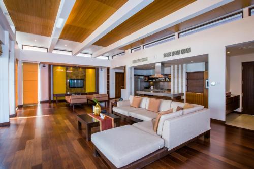 a living room with a couch and a table at Mövenpick Resort Bangtao Beach Phuket in Bang Tao Beach