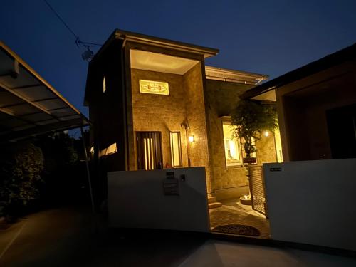 a house with a door in front of it at night at リゾートヴィラ宮島 Sunset terrace in Hatsukaichi