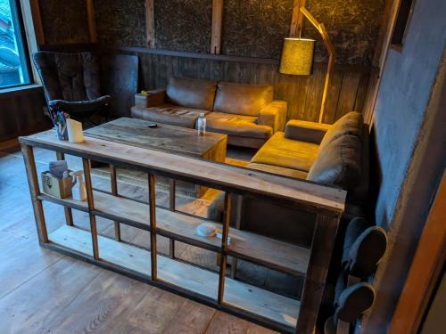 a living room with a couch and a table at 民泊やがみ-Yagami- in Sanagu