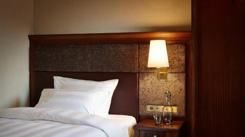 a hotel room with two beds and a lamp at Lotte Arai Resort in Myoko