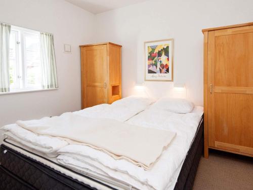 a large white bed in a room with a window at Luxury Retreat in Blavand - By Traum Ferienwohnungen in Blåvand