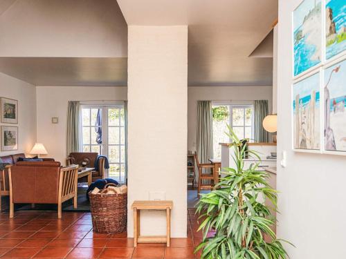 a living room with a plant in the middle at Luxury Retreat in Blavand - By Traum Ferienwohnungen in Blåvand