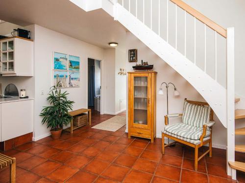 a living room with a staircase and a chair at Luxury Retreat in Blavand - By Traum Ferienwohnungen in Blåvand