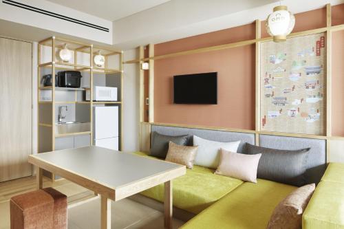 a living room with a couch and a table at OMO5 Kyoto Gion by Hoshino Resorts in Kyoto