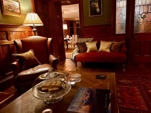a living room with a couch and a table at Clashmore House in Dornoch
