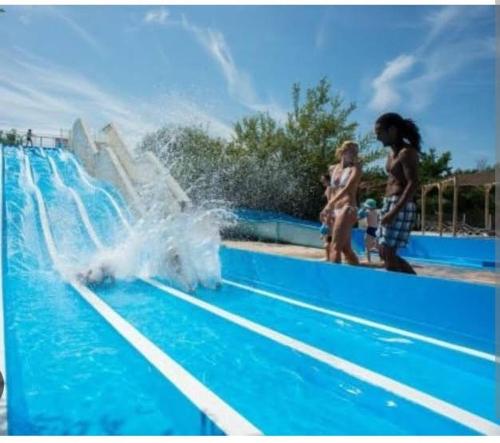 two people standing in front of a water fountain at WOW Holidays - 8 Person, 5 Star Mobile-Home with Terrace in Gastes