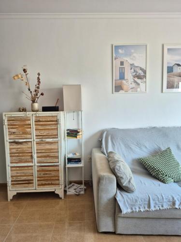 a living room with a couch and a dresser at Ático Loft Vera Playa in Vera