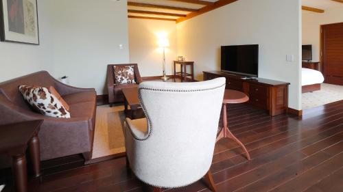 a living room with a couch and a chair at Lotte Arai Resort in Myoko