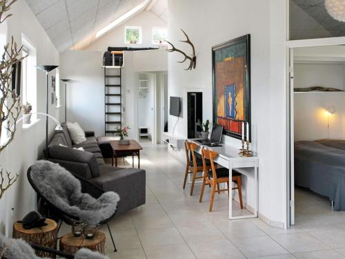 a living room with a couch and a table at 8 person holiday home in Børkop in Børkop